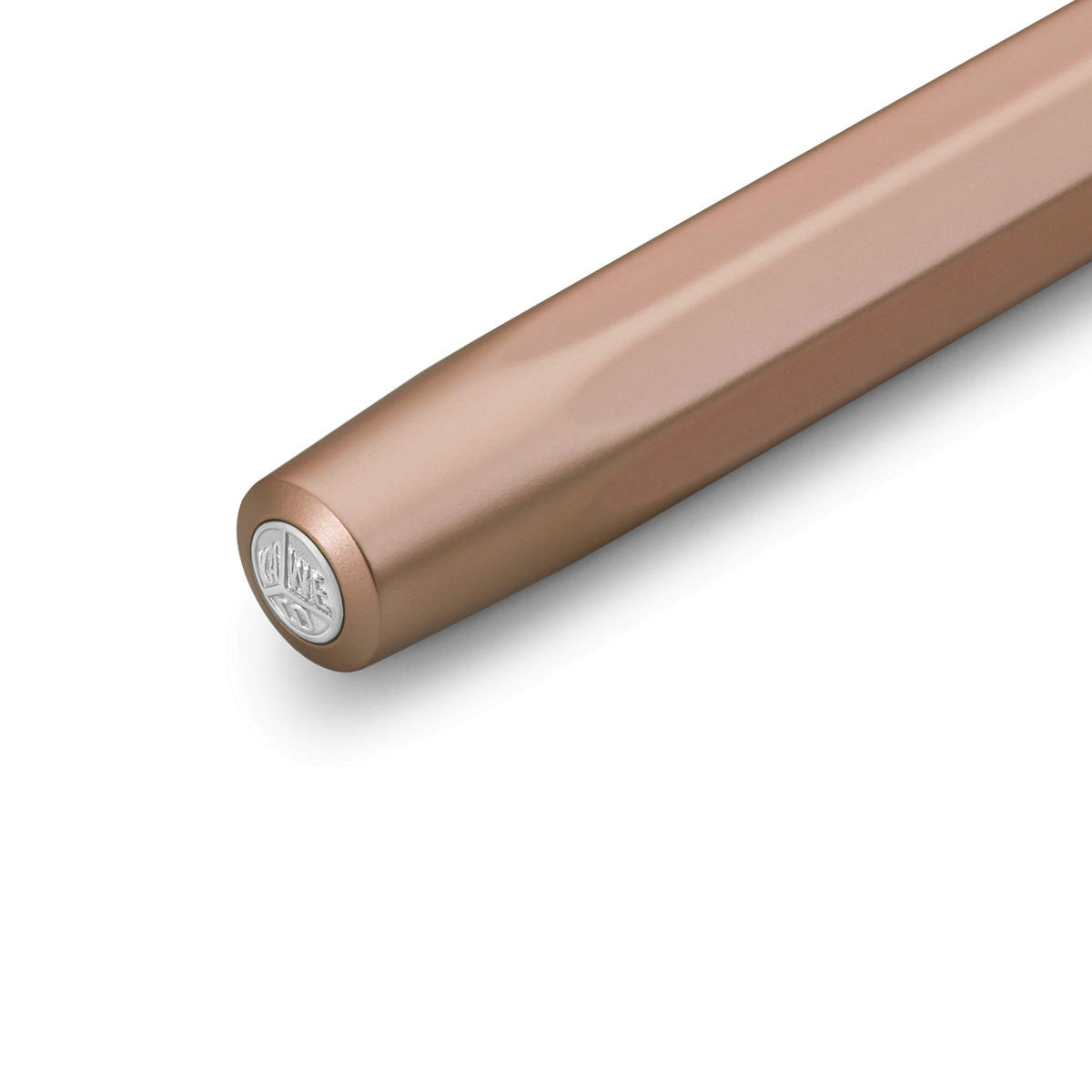 Cap of a pink gold pen with a round silver medallion displaying the KAWECO  inscription.