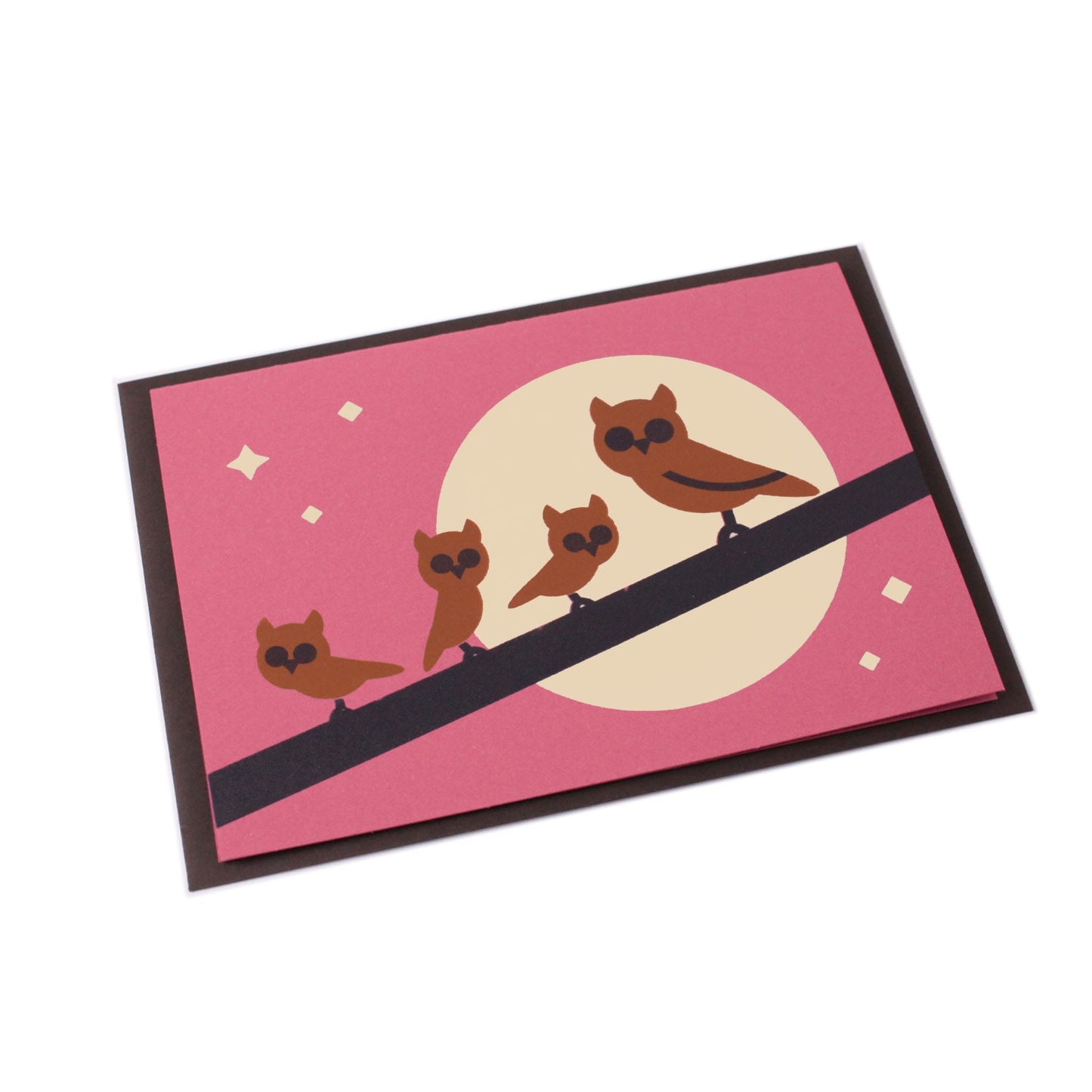 Illustrated card with brown owls on a branch, moon, stars in the background, accompanied by a brown envelope.