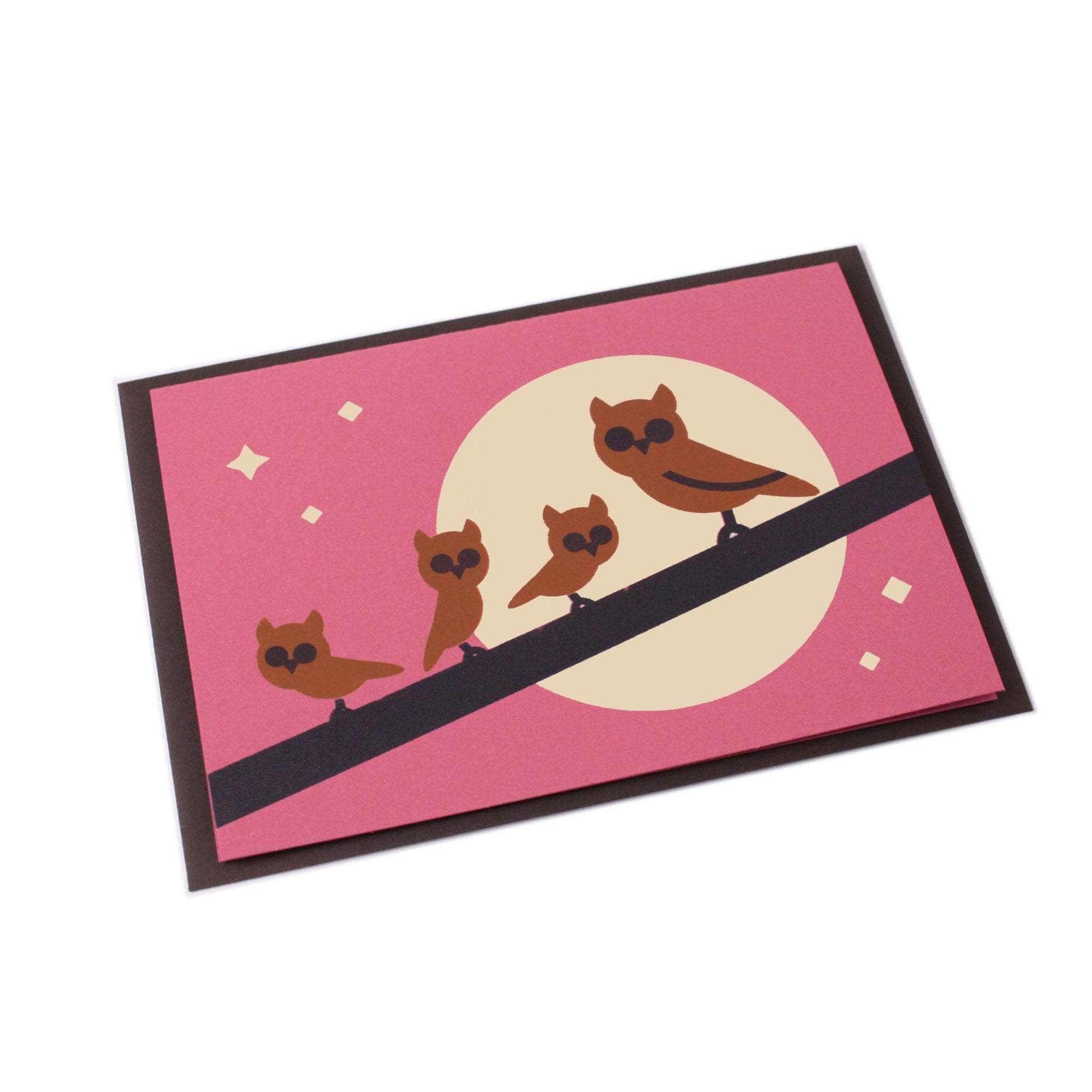 Illustrated card with brown owls on a branch, moon, stars in the background, accompanied by a brown envelope.