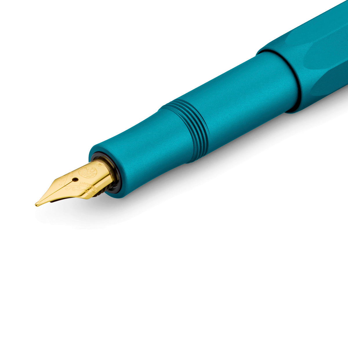 Close-up view of a turquoise fountain pen with a gleaming gold nib.