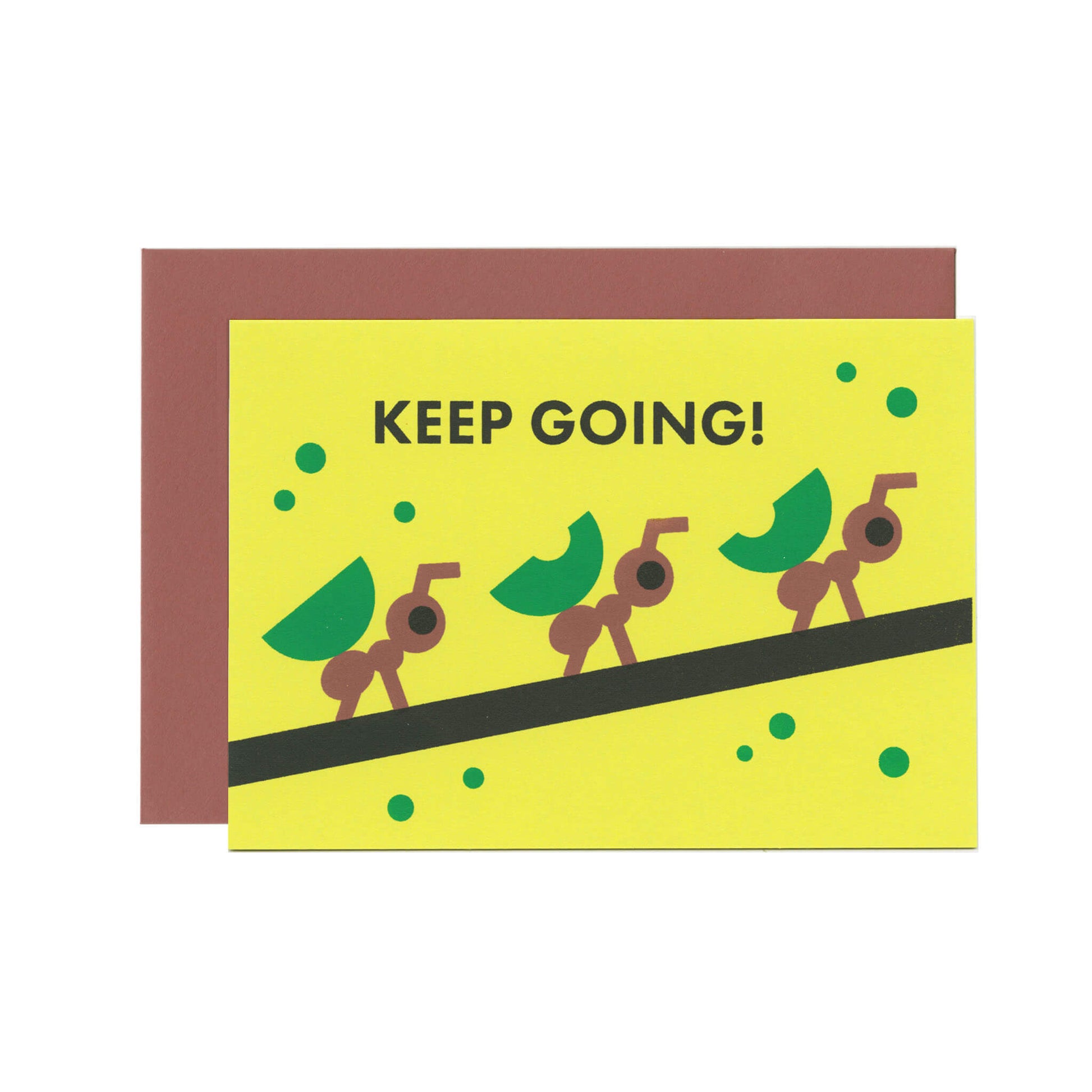 A yellow-green greeting card with a text that reads "Keep going!" and an illustration of ants carrying leaves in a row on a branch. There's a brown envelope behind the card.