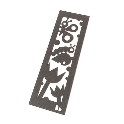 A dark brown paper bookmark with cut-outs of a butterfly, a caterpillar on a leaf, and two tulips at the bottom on a white background.
