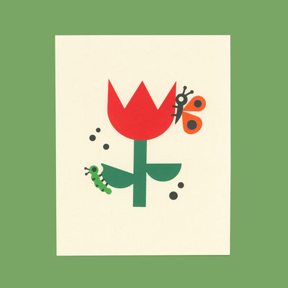 An art print of an illustration of a caterpillar and butterfly on a tulip displayed on a green background.