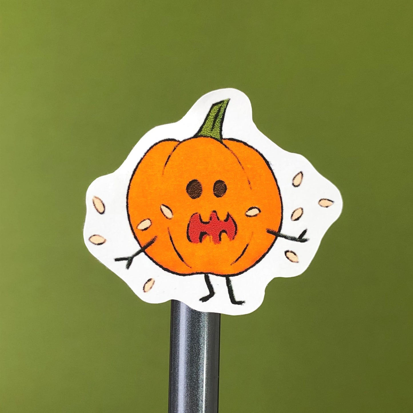 Cartoon Pumpkin Sticker on a pencil from close view.