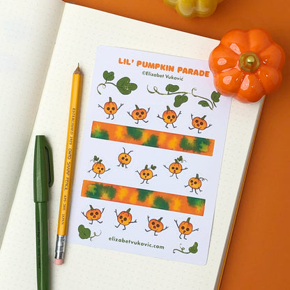 Small pumpkins and washi tape stickers beside pens.