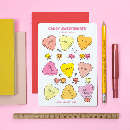 Candy Hearts Valentines Sticker sheet beside pens and notebooks.