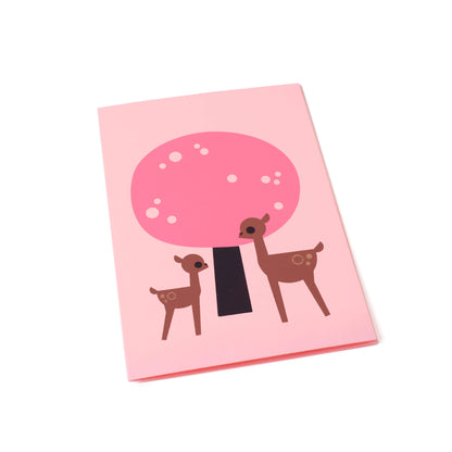 A greeting card with an illustration of a pink cherry blossom tree with two deer standing in front, one small and the other larger, against a pink background.