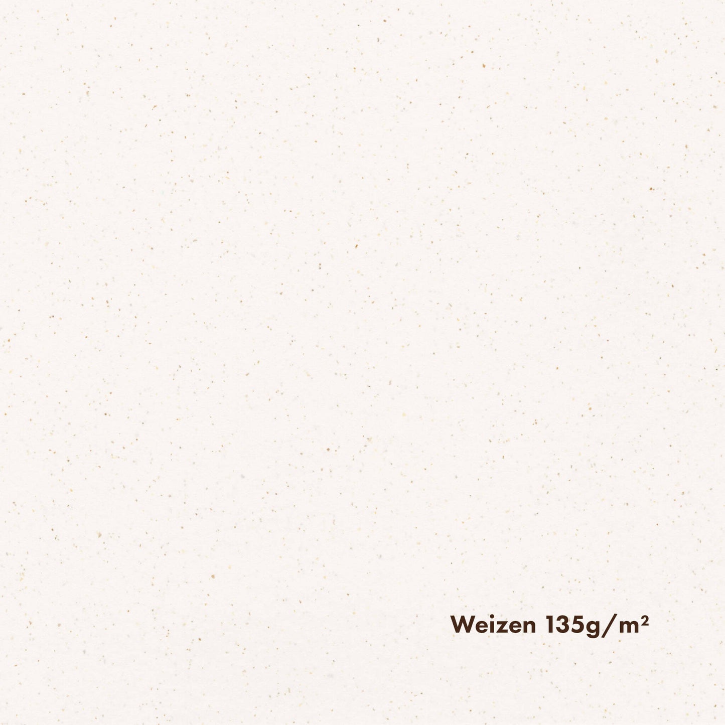 Close-up of white-toned pulp paper with noticeable brown speckles, with the text 'Weizen 135g/m2' printed on it.