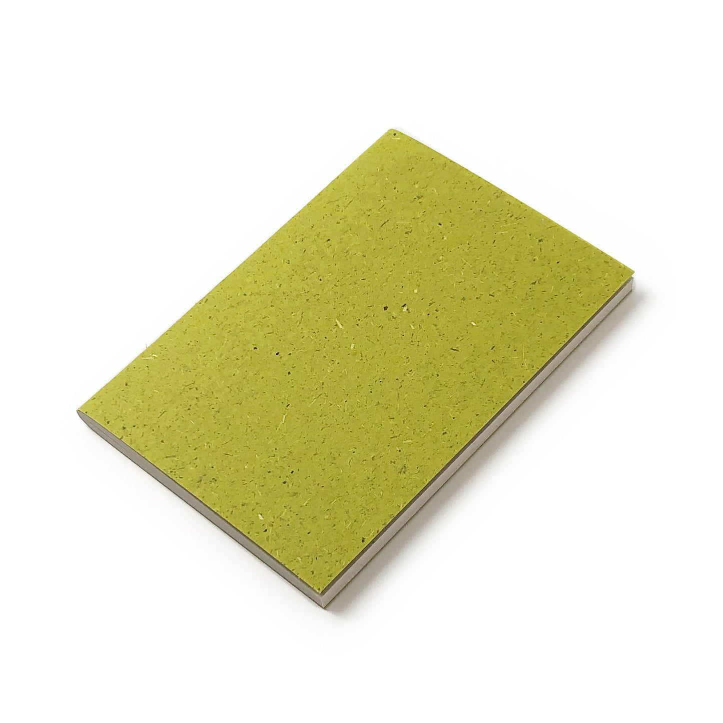 Green notebook with grass-textured cover and white pages on a white background.