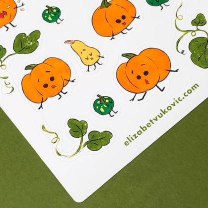 Illustrations of pumpkins and leaves on a sheet from close view at the bottom a website reads elizabetvukovic.com