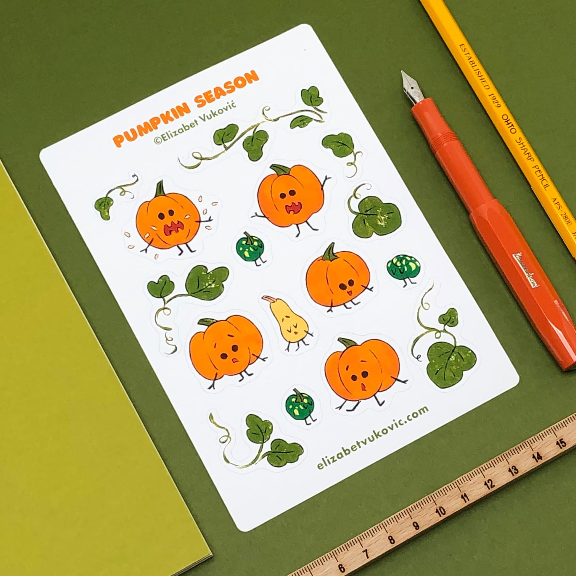 Pumpkins Season sticker sheet featuring illustrations of cartoon pumpkins placed next to a notebook, pencil, fountain pen and ruler.