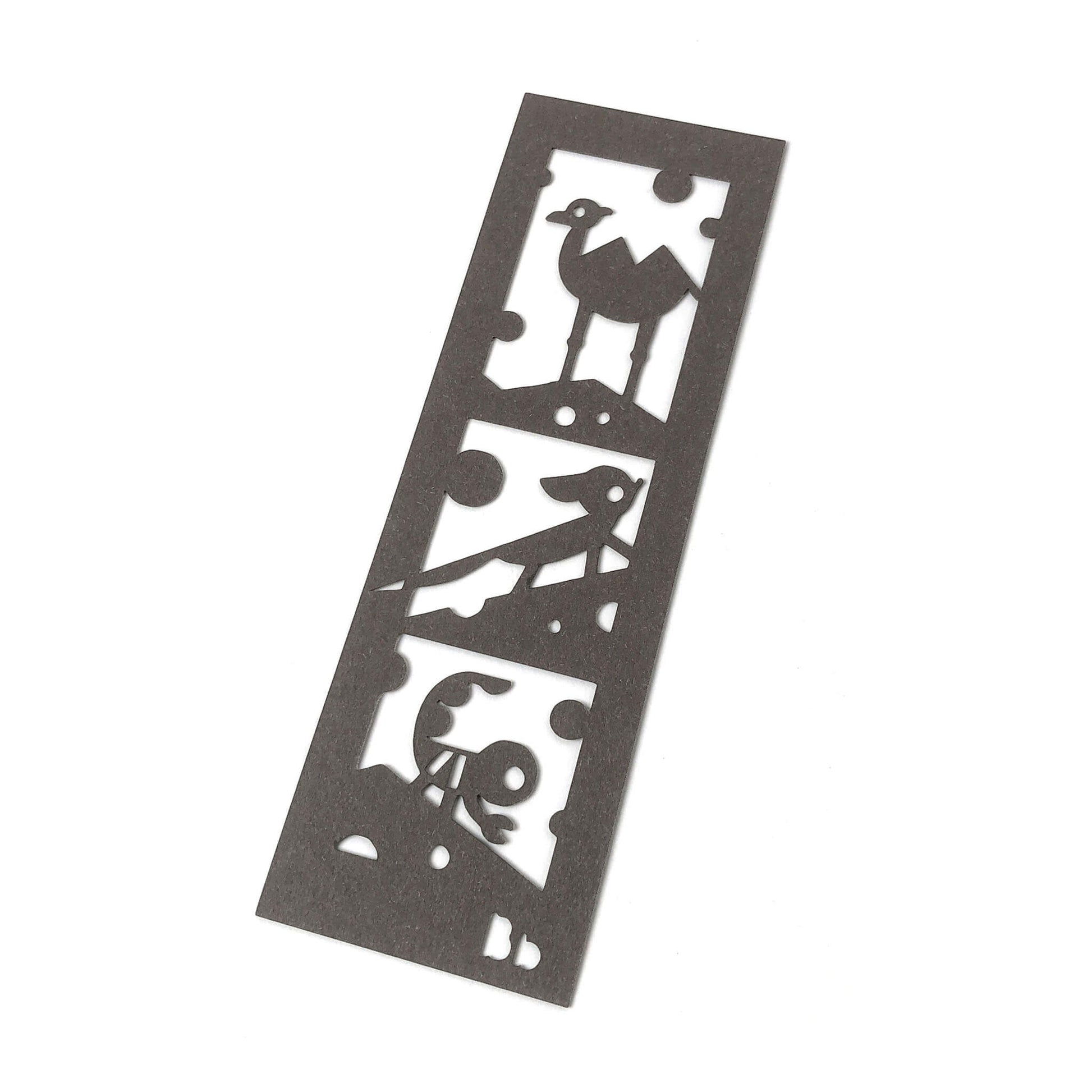 A dark brown paper bookmark with cut-outs of a camel, fennec fox, scorpion and Bb on a white background.
